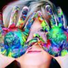 a kid with multicolored hand paint
